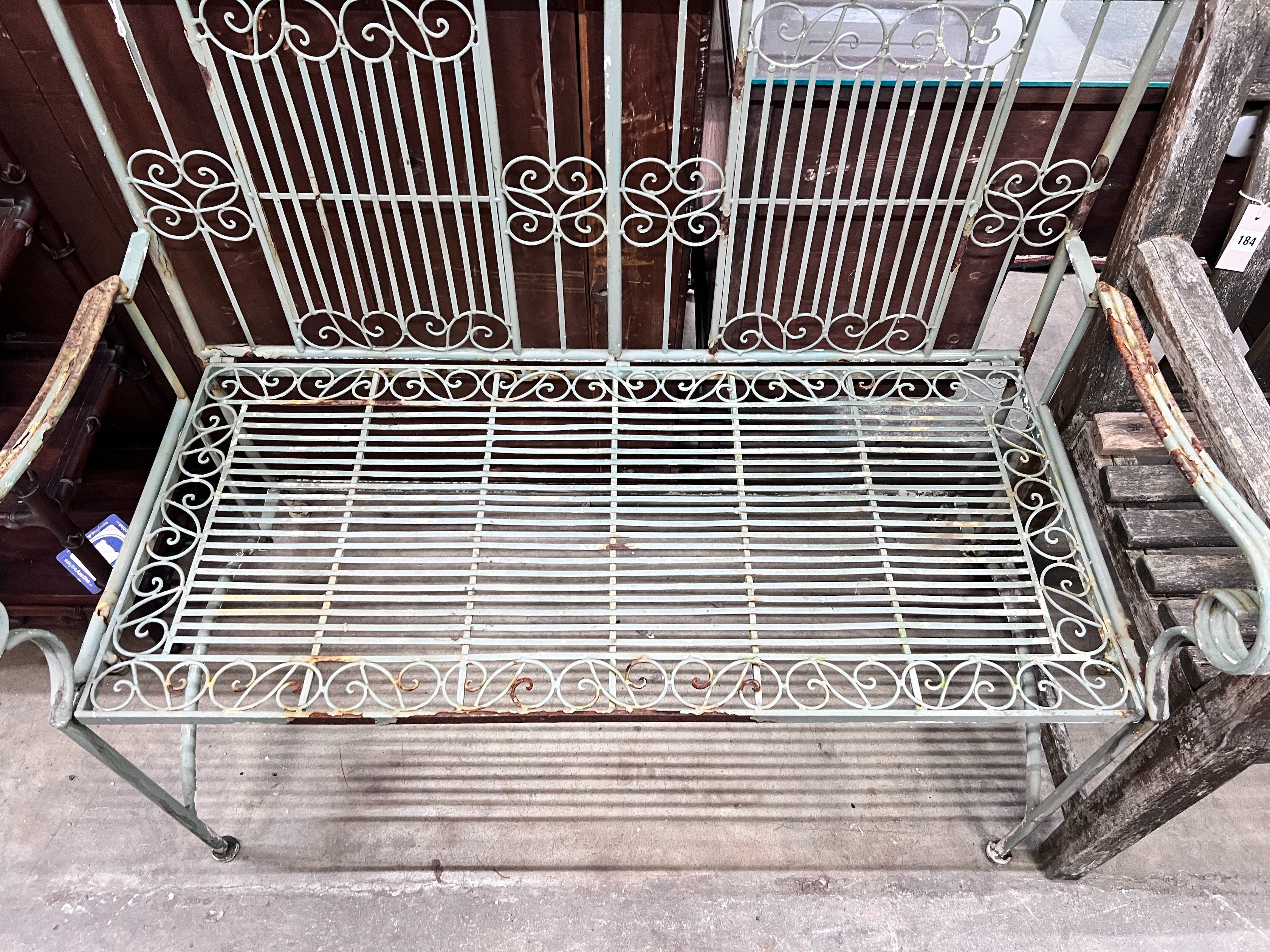 A painted wrought iron folding garden bench, width 108cm *Please note the sale commences at 9am.